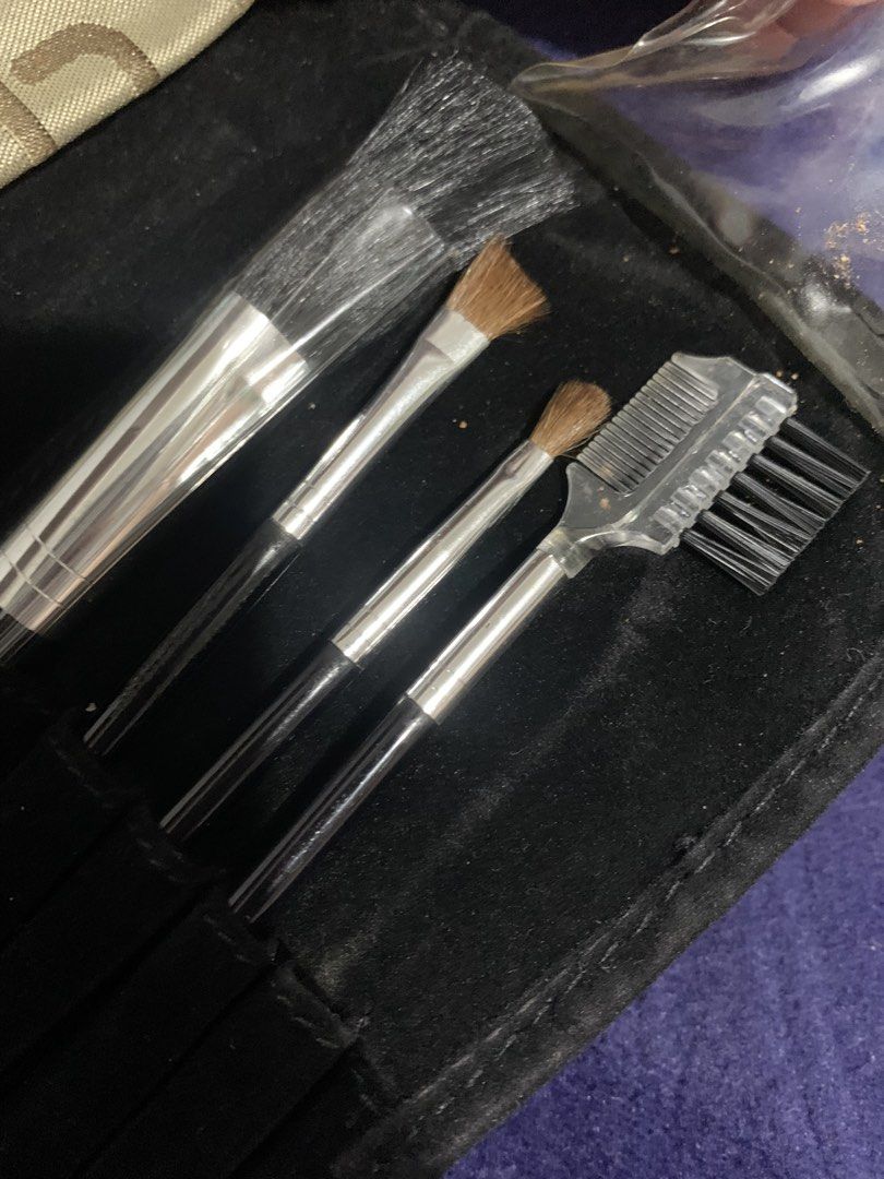 Makeup Brush Set with Travel Case and Mirror (Category: Makeup) located in Pasig City. Submitted by miswatamita (Listing ID 1457750563, Image 2). Description: - Compact makeup brush set - Includes a zippered pouch with a patterned exterior - Small mirror inside the case - Brushes feature silver handles and black bristles - Ideal for travel or daily use - Keeps your brushes organized and protected.