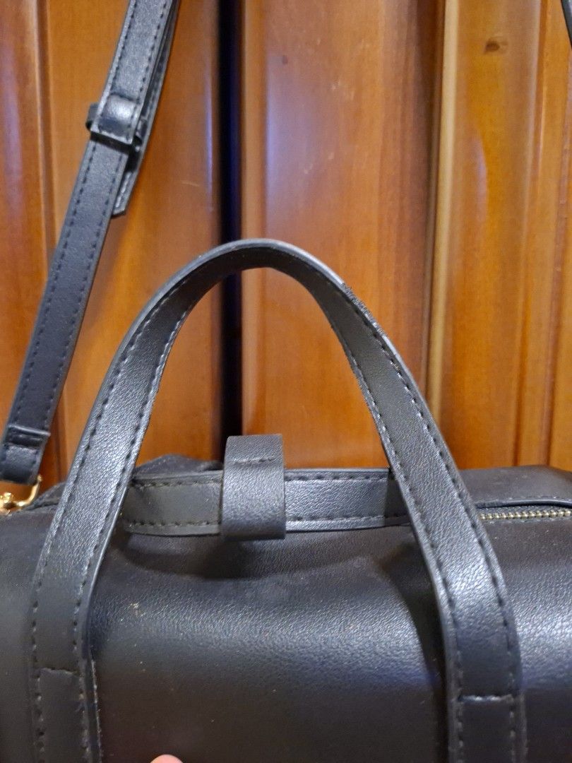 Mini Doctors Bag with sling (Category: Shoulder Bags) located in Manila. Submitted by bagsandstuff0721 (Listing ID 1457843965, Image 2). Description: - Sleek black leather cylinder bag - Versatile top handle and detachable shoulder strap - Elegant gold hardware details - Secure zipper closure - Ideal for everyday use or a night out - Fits all your essentials.
