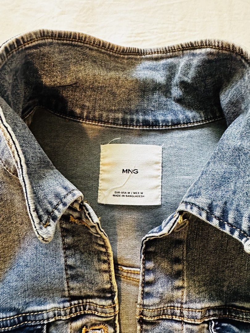 MNG Denim Jacket Blue Size M (Category: Coats, Jackets and Outerwear) located in Muntinlupa City. Submitted by nptorres (Listing ID 1457748562, Image 2). Description: - Classic blue denim jacket from MNG - Size: Medium (M) - Button-up front closure - Two chest pockets - Long sleeves with button cuffs - Versatile for layering over any outfit - Made in Bangladesh.