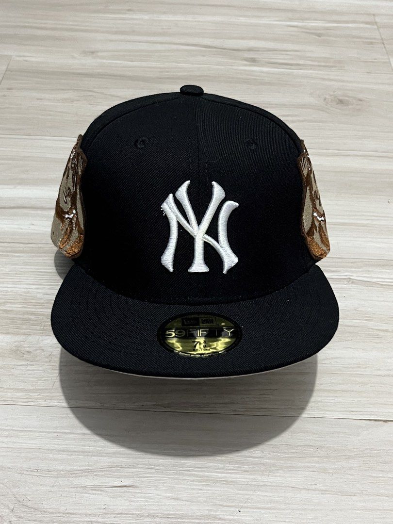 New Era 59FIFTY Yankees Cap (Category: Caps & Hats) located in Legazpi City. Submitted by tr3ymann (Listing ID 1457865882, Image 1). Description: - Brand New Era 59FIFTY Cap - Color: Black - Team Logo: White New York Yankees logo - Unique Detail: Brown and gold accents on the sides - Size: 7 3/8 .