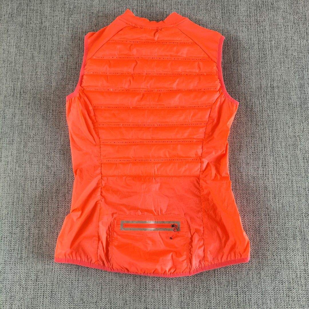 Nike Running Puffer Vest Orange M (Category: Vests) located in Taytay. Submitted by calmtree-6248 (Listing ID 1457738067, Image 2). Description: - Bright orange Nike running vest - Size: Medium - Lightweight and sleeveless design - Full zip front closure - Zippered pocket on the back - Perforated details for enhanced breathability - Perfect for running and workouts.