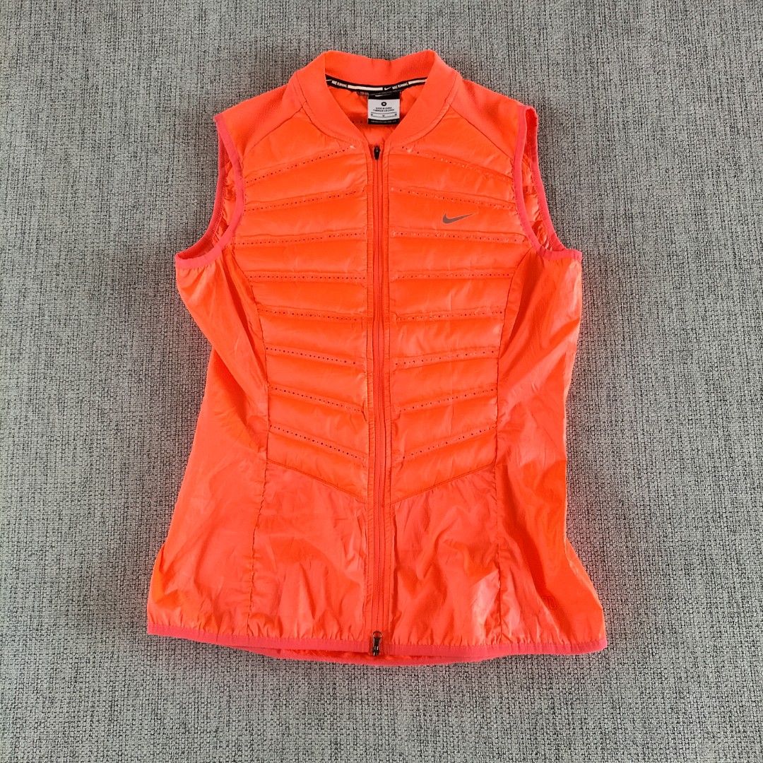Nike Running Puffer Vest Orange M (Category: Vests) located in Taytay. Submitted by calmtree-6248 (Listing ID 1457738067, Image 1). Description: - Bright orange Nike running vest - Size: Medium - Lightweight and sleeveless design - Full zip front closure - Zippered pocket on the back - Perforated details for enhanced breathability - Perfect for running and workouts.