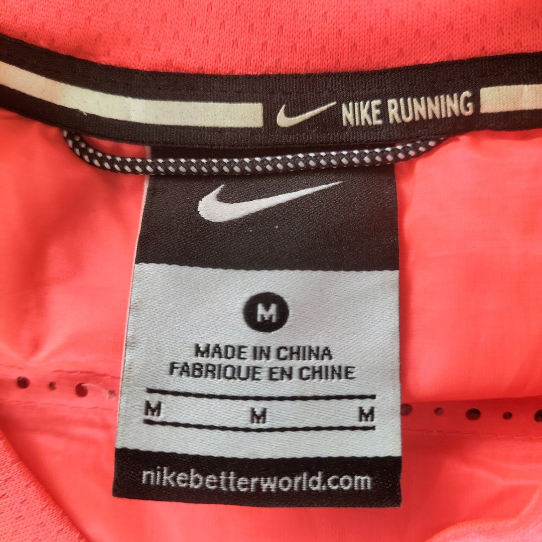 Nike Running Puffer Vest Orange M (Category: Vests) located in Taytay. Submitted by calmtree-6248 (Listing ID 1457738067, Image 3). Description: - Bright orange Nike running vest - Size: Medium - Lightweight and sleeveless design - Full zip front closure - Zippered pocket on the back - Perforated details for enhanced breathability - Perfect for running and workouts.