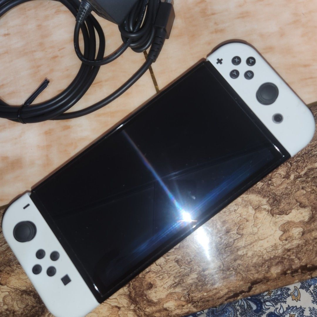 Nintendo Switch OLED White Console with Accessories (Category: Nintendo) located in Bulacan. Submitted by anna.t0 (Listing ID 1457902951, Image 2). Description: Nintendo Switch OLED Model (White) CONDITION: • Used but well taken care of • Has minimal scratches from normal use • Scratches are only cosmetic and do not affect gameplay or performance • No issues whatsoever — everything is working properly • Ready to use and play 📦 COMPLETE ACCESSORI