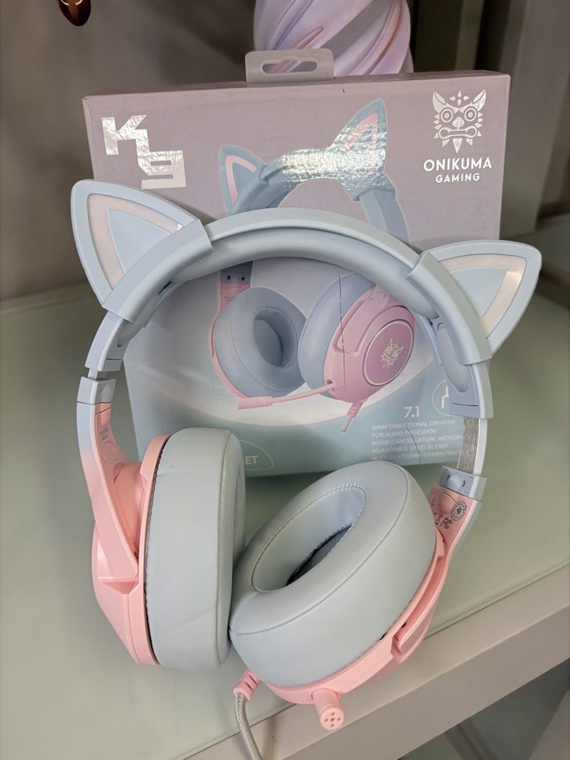 ONIKUMA K9 Gaming Headset with Cat Ears (Category: Headphones & Headsets) located in Manila. Submitted by tinmah (Listing ID 1457740743, Image 3). Description: - Cute ONIKUMA K9 gaming headset - Available in pink and light blue - Adorable cat ear design (detachable) -RGB light - USB connector and durable braided cable - Soft and comfortable earcups for long wear - Ideal for gaming and music listening - Original box included.