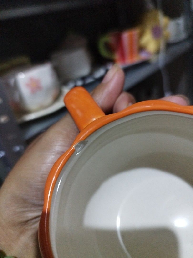 Orange Pumpkin Face Mug (Category: Coffee & Tea Tableware) located in Manila. Submitted by silverwhale_cafa21 (Listing ID 1457866614, Image 3). Description: - Adorable orange mug shaped like a pumpkin. - Features a carved jack-o'-lantern face. - Ideal for Halloween or fall-themed beverages. - Easy-to-grip handle. 📌📌with Paint Chip sa mouth.