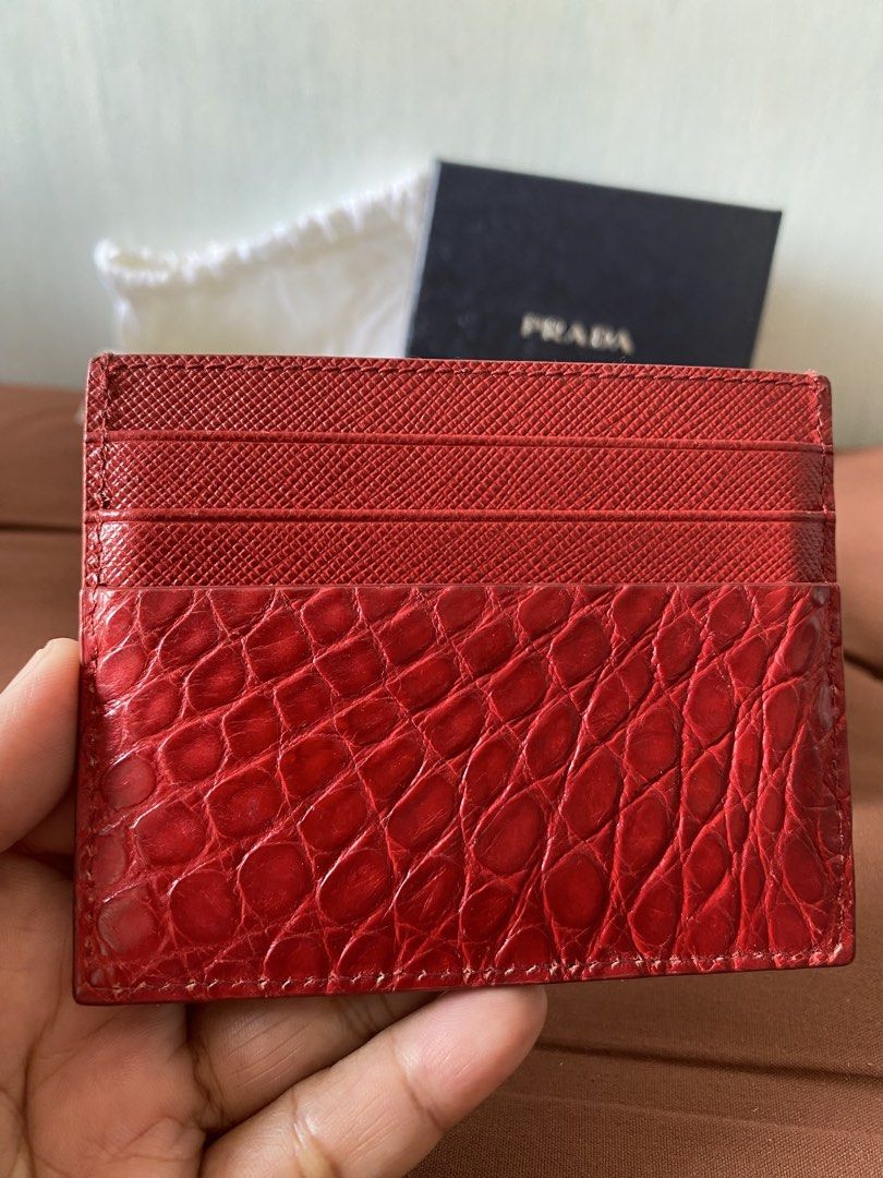 Prada Red Crocodile Embossed Leather Card Holder (Category: Luxury Bags & Wallets) located in Taguig. Submitted by sandzclick (Listing ID 1457755642, Image 3). Description: - Authentic Prada card holder - Stunning red color with crocodile embossed leather - Elegant gold Prada logo on the front - Multiple card slots for organization - Comes with original box, dust bag, and authenticity card - Perfect for stylishly organizing your cards.