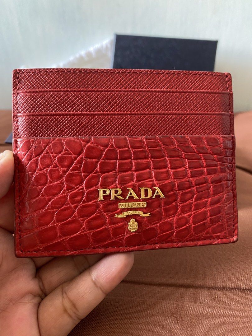 Prada Red Crocodile Embossed Leather Card Holder (Category: Luxury Bags & Wallets) located in Taguig. Submitted by sandzclick (Listing ID 1457755642, Image 1). Description: - Authentic Prada card holder - Stunning red color with crocodile embossed leather - Elegant gold Prada logo on the front - Multiple card slots for organization - Comes with original box, dust bag, and authenticity card - Perfect for stylishly organizing your cards.