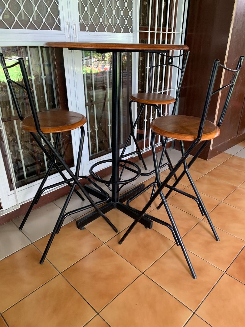 PRE-LOVED BAR TABLE + 3 HIGH CHAIRS SET (Category: Tables & Sets) located in Paranaque City. Submitted by juliusd23 (Listing ID 1457739222, Image 2). Description: Looking for a stylish and functional bar/dining set without spending a fortune? 🍻☕🍽️ Selling this pre-loved 4-piece Bar Table Set — 1 wooden bar table + 3 matching high chairs. ✨ WHAT YOU GET: • 1 Round Wooden Bar Table • 3 Matching High Chairs • Solid wooden tops/seats • Sturdy black
