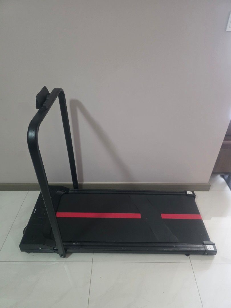 Python Walkpad (Category: Cardio & Fitness Machines) located in Singapore. Submitted by qndcollection (Listing ID 1457892462, Image 2). Description: - Compact walkpad for home use - Black with two red stripes on the belt - Folds for easy storage - Sturdy handles for support - Ideal for quick workouts - Ready for a new home.