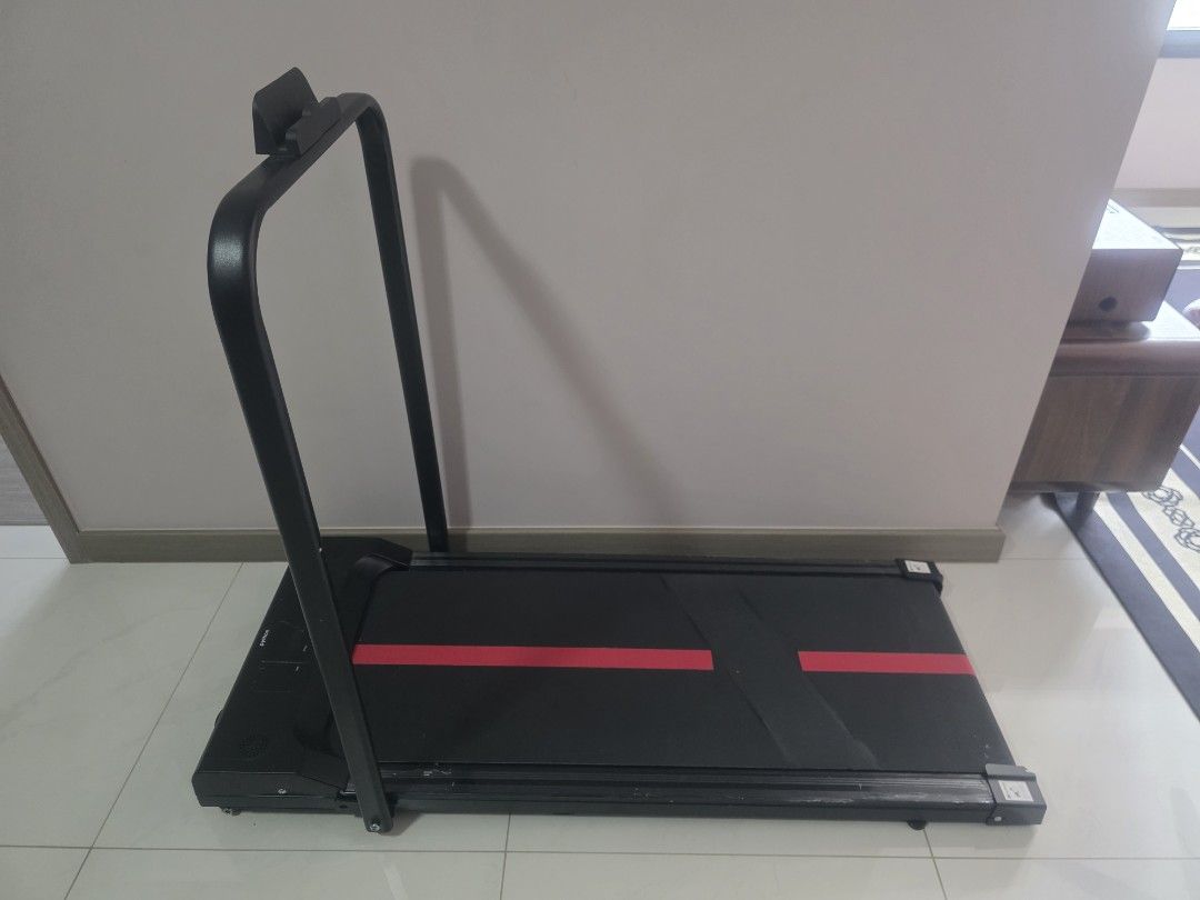 Python Walkpad (Category: Cardio & Fitness Machines) located in Singapore. Submitted by qndcollection (Listing ID 1457892462, Image 3). Description: - Compact walkpad for home use - Black with two red stripes on the belt - Folds for easy storage - Sturdy handles for support - Ideal for quick workouts - Ready for a new home.