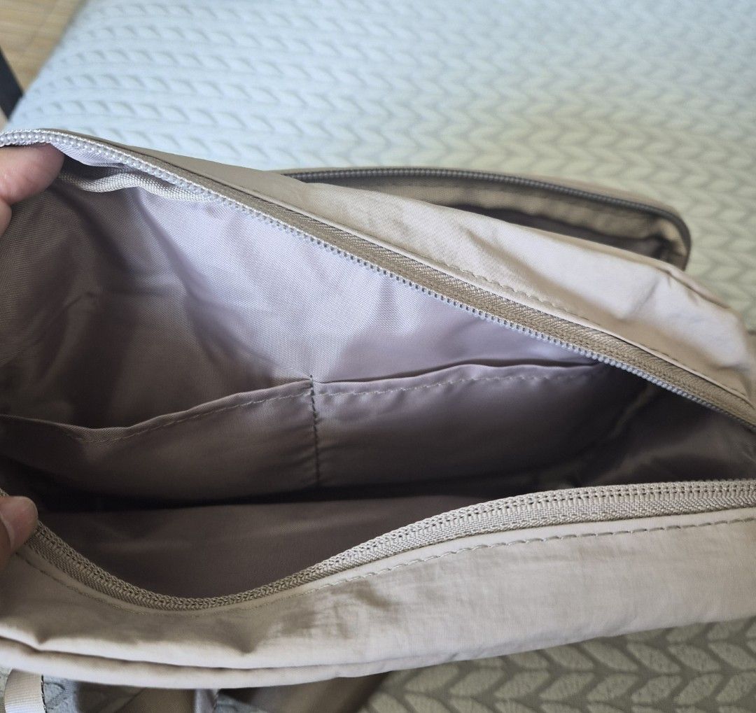 Quilted Crossbody Bag with Detachable Pouch (Category: Cross-body Bags) located in Quezon City. Submitted by deng43763 (Listing ID 1457742328, Image 2). Description: - Lightweight quilted crossbody bag in neutral beige. - Main compartment with internal pockets. - Front zipper pocket for quick access. - Includes a small detachable quilted pouch. - Adjustable strap for comfortable carrying. - Ideal for everyday adventures..