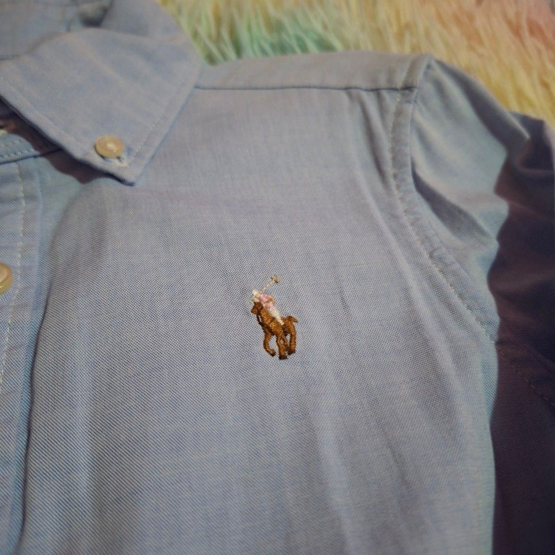 Ralph Lauren light blue logo dress (Category: Babies & Kids Fashion) located in Las Pinas. Submitted by assortedkidzstuffs (Listing ID 1457830043, Image 3). Description: This light blue cotton oxford shirt dress by Polo Ralph Lauren features a classic button-down front, long sleeves, and a flared pleated skirt accented with the brand's signature embroidered pony logo like new. worn once saglit tag size 7.