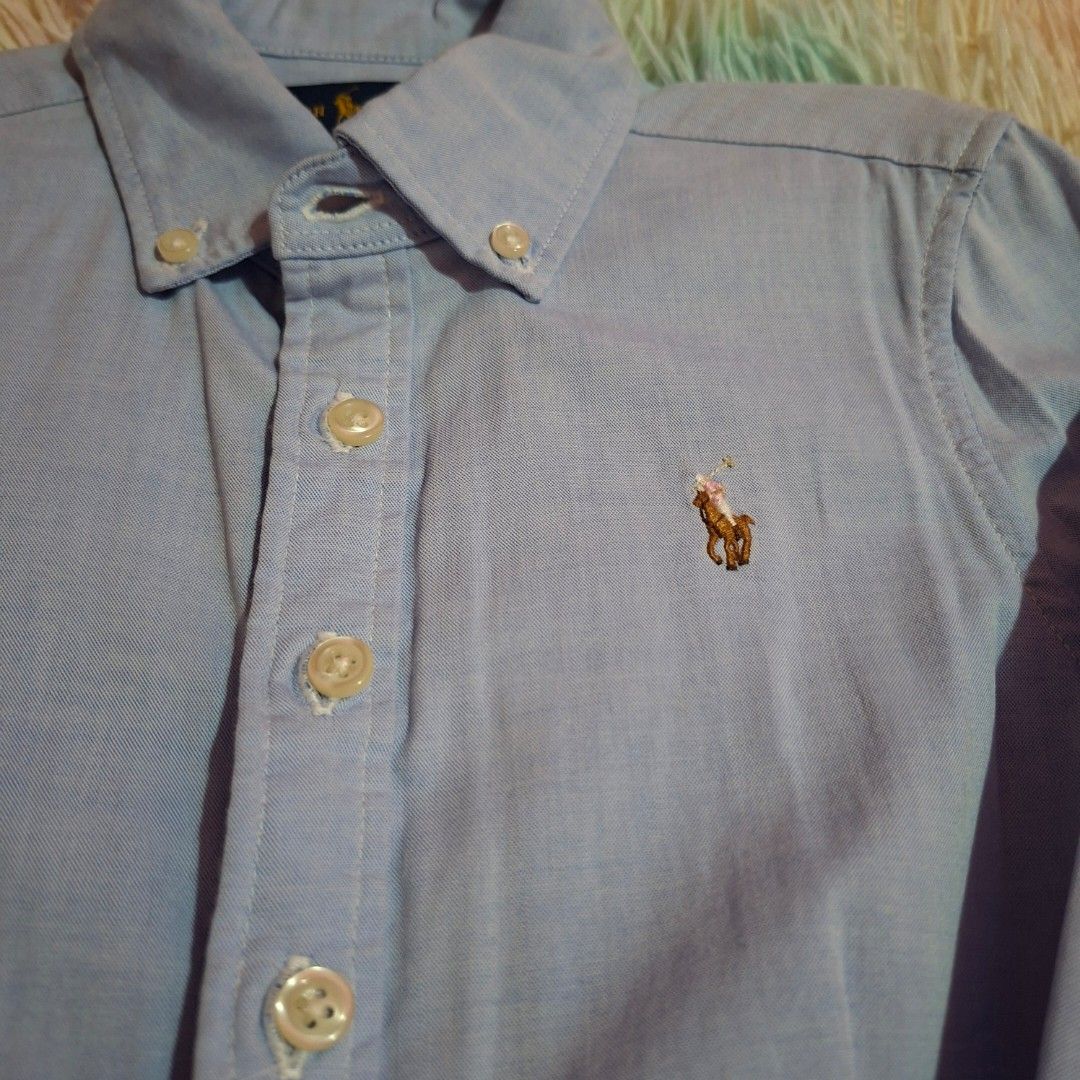 Ralph Lauren light blue logo dress (Category: Babies & Kids Fashion) located in Las Pinas. Submitted by assortedkidzstuffs (Listing ID 1457830043, Image 2). Description: This light blue cotton oxford shirt dress by Polo Ralph Lauren features a classic button-down front, long sleeves, and a flared pleated skirt accented with the brand's signature embroidered pony logo like new. worn once saglit tag size 7.