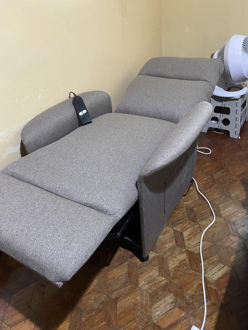 Recliner chair- bed (Category: Other Home Decor) located in Marikina City. Submitted by igmtsisters (Listing ID 1457822985, Image 2). Description: Bought for php20K in SM. The Milano Power Recliner features soft gray fabric upholstery, a high backrest, and an electric reclining mechanism controlled by a handheld remote. Ergonomic Design: Segmented backrest cushioning and padded flared armrests provide full lumbar and upper body support. Gray text