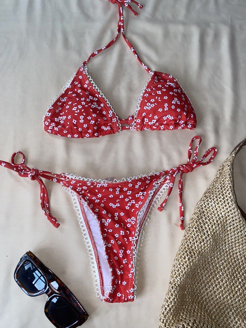 Red floral print bikini with white trim (Category: Bikinis & Swimsuits) located in Tarlac. Submitted by rieselects (Listing ID 1456579698, Image 1). Description: - Adorable red bikini with a charming white floral print. - Features delicate white lace trim along the edges for a feminine touch. - Adjustable ties at the neck and sides ensure a perfect, customized fit. - Flattering thong-style bottoms. - Ideal for your next beach vacation or poolside