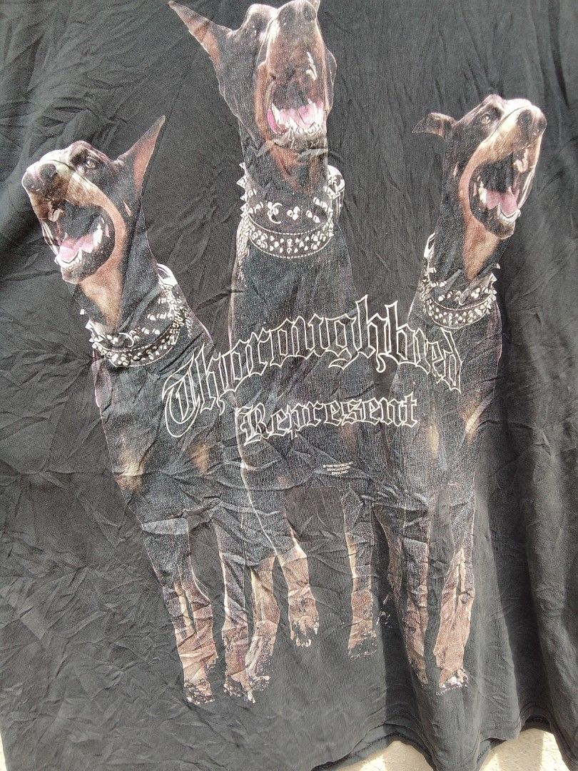 Represent "Thoroughbred" Graphic Tee XL Black (Category: Tshirts & Polo Shirts ) located in Alicia. Submitted by rhos420.bimps (Listing ID 1457759303, Image 2). Description: - Brand: Represent - Color: Black - Size: XL - Graphic Print: Three Dobermans with 'Thoroughbred Represent' text - Copyright: 1990 - Style: Streetwear essential.