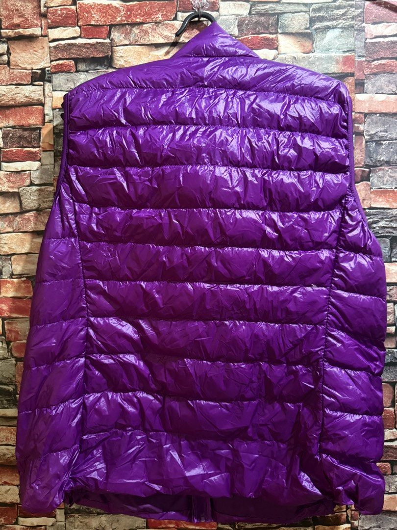 UNISEX Purple Lightweight Puffer Vest (Category: Coats, Jackets and Outerwear) located in Lipa City. Submitted by vtech47631 (Listing ID 1457779015, Image 2). Description: - Vibrant purple sleeveless puffer vest - High collar for extra warmth - Full zip front closure - Two zippered pockets for secure storage - Lightweight and easy to pack - Ideal for layering over other clothing.