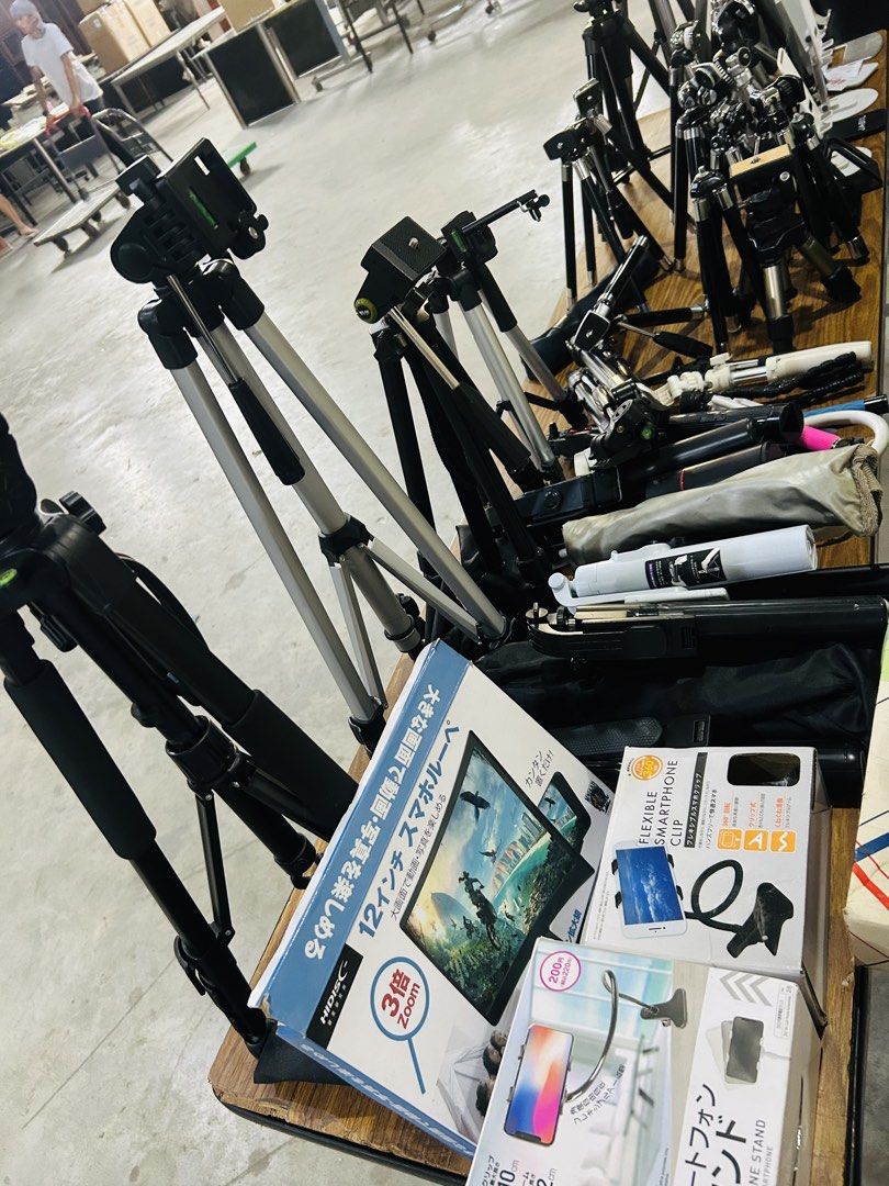 Various Tripods, Monopods, and Phone Mounts (Category: Tripods & Monopods) located in Manila. Submitted by starbalesukandjapansurplus (Listing ID 1457777730, Image 3). Description: - Collection of camera and phone accessories - Includes various sizes of tripods - Some monopods available - Phone holders included - Ideal for photography and videography enthusiasts - Some items still in original packaging - Bundle deal offered for the entire lot - E