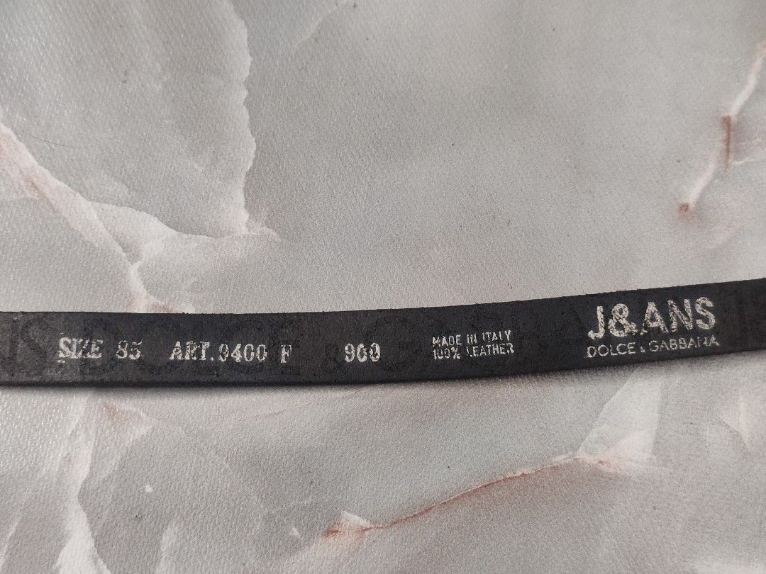Vintage Dolce & Gabbana Leather Belt (Category: Belts) located in Taguig. Submitted by inzanne.vesture (Listing ID 1457788693, Image 2). Description: - Authentic Dolce & Gabbana belt - Size 26 - 32 Width - Color: Black leather - Buckle: Silver with J&GANS logo - Material: 100% Leather - Size: 85 - Origin: Made in Italy - Condition: Shows some wear on leather and buckle, consistent with use. Still a great statement piece..