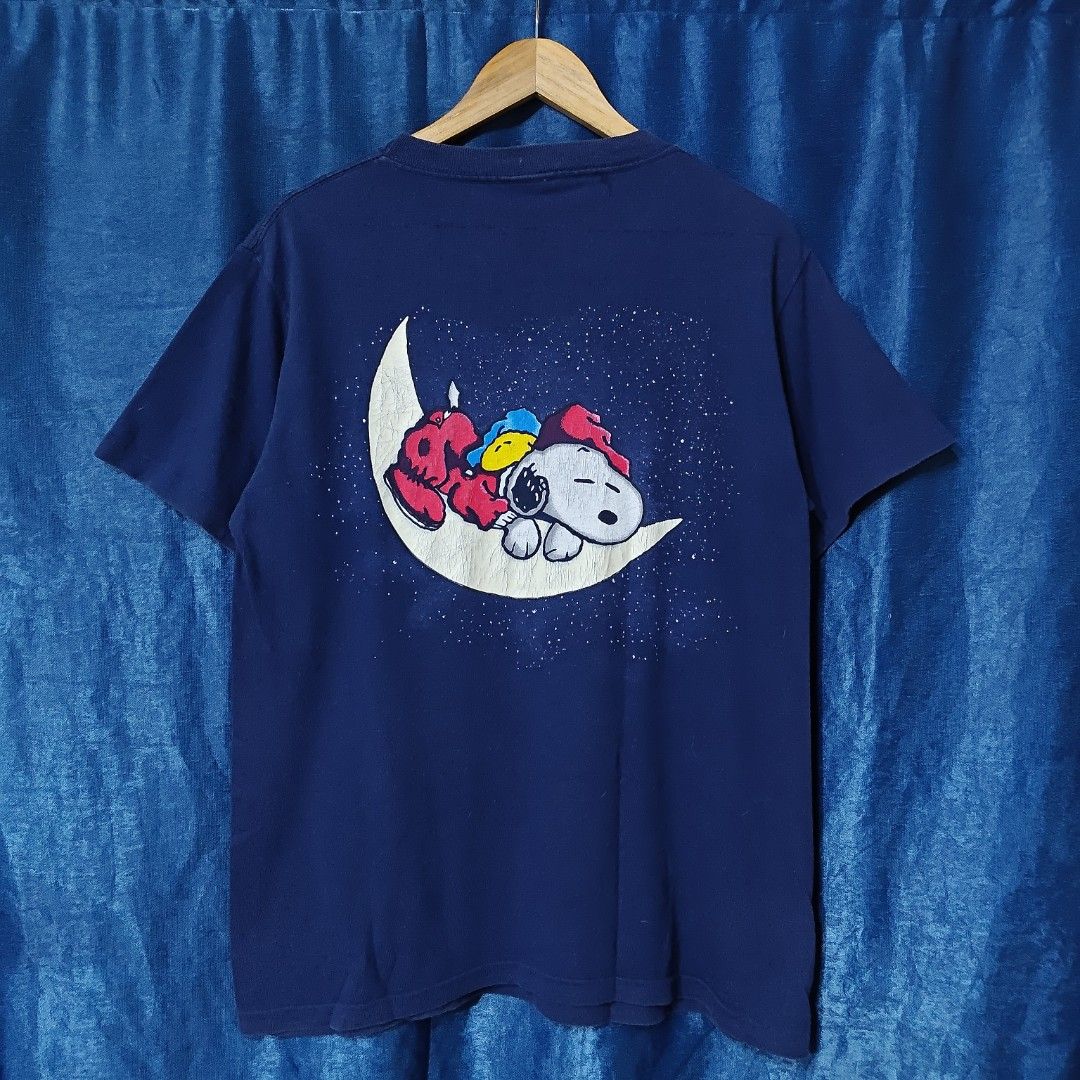 VINTAGE SNOOPY PEANUTS GLOW IN THE DARK TEE (Category: Tshirts & Polo Shirts ) located in Makati City. Submitted by upcycled.closeth (Listing ID 1457743805, Image 3). Description: - Authentic vintage snoopy peanuts product - Navy blue, Short-sleeved - Size: Medium to large (men's) - Tag: 90's Changes tag - Authentic - flaws: no flaws - Excellent condition - Need wash, fresh from bale - Features design of Snoopy peanuts glow in the dark - Material
