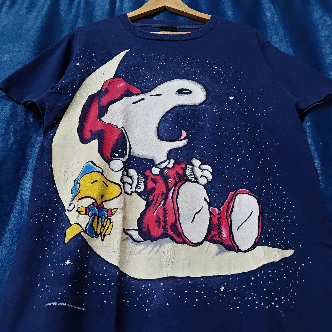 VINTAGE SNOOPY PEANUTS GLOW IN THE DARK TEE (Category: Tshirts & Polo Shirts ) located in Makati City. Submitted by upcycled.closeth (Listing ID 1457743805, Image 2). Description: - Authentic vintage snoopy peanuts product - Navy blue, Short-sleeved - Size: Medium to large (men's) - Tag: 90's Changes tag - Authentic - flaws: no flaws - Excellent condition - Need wash, fresh from bale - Features design of Snoopy peanuts glow in the dark - Material
