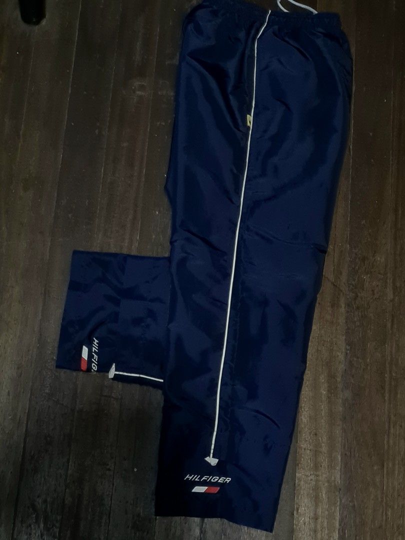Vintage Tommy Hilfiger Track Pants (Category: Joggers) located in Pateros City. Submitted by paoef (Listing ID 1457815261, Image 2). Description: Vintage Tommy Hilfiger Hilfiger Athletics Nylon Track Pants -Size M-L -9/10 condition -Garter still crispy -2 deep pockets on the side -Silky nylon with inner mesh -NO KNOWN ISSUE W: 28-36 L: 40.5 Thighs: 13 Hem: 9.