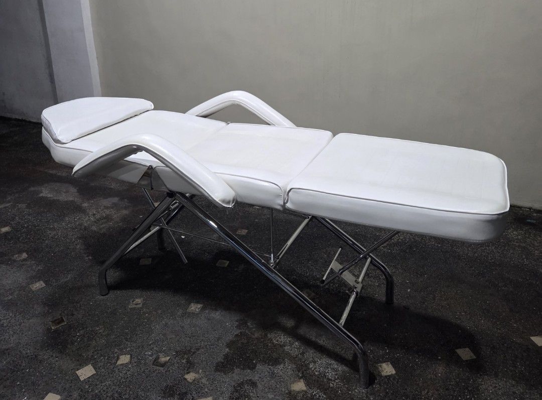 White Adjustable Massage Bed with Face Cradle (Category: Massage Devices) located in Quezon City. Submitted by unimo0212 (Listing ID 1457866907, Image 2). Description: - White massage/facial bed - Ideal for spa, salon, or home use -Perfect for massage, facial, tattoo, piercing, beauty, spa salon and skin clinic -Adjustable back and leg rest to diff angles -Includes removable face cradle pillow -Sturdy metal frame for durability -3 fold padded wit