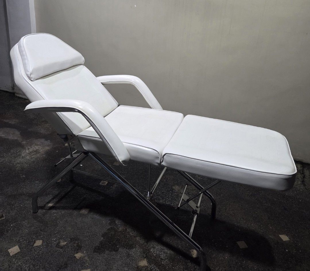 White Adjustable Massage Bed with Face Cradle (Category: Massage Devices) located in Quezon City. Submitted by unimo0212 (Listing ID 1457866907, Image 3). Description: - White massage/facial bed - Ideal for spa, salon, or home use -Perfect for massage, facial, tattoo, piercing, beauty, spa salon and skin clinic -Adjustable back and leg rest to diff angles -Includes removable face cradle pillow -Sturdy metal frame for durability -3 fold padded wit