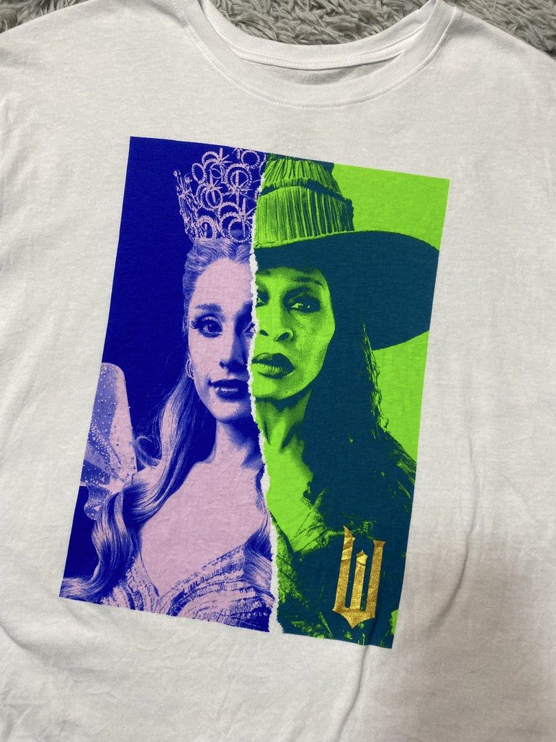 Wicked Glinda & Elphaba Shirt (Category: Tshirts & Polo Shirts ) located in Solano. Submitted by solothrifting (Listing ID 1457737596, Image 3). Description: Wicked Glinda & Elphaba Shirt Condition: 9.5/10 Size on tag: L.