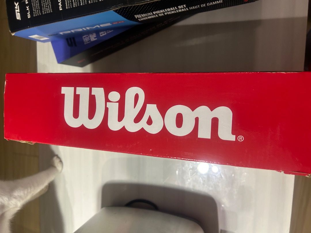 Wilson Profile Team Pickleball Kit with 2 Balls (Category: Racket and Ball Sports) located in Cavite. Submitted by thriftqueen.phhhhh (Listing ID 1457887853, Image 2). Description: - Wilson pickleball kit, perfect for beginners. - Includes: 1 paddle and 2 pickleballs. - Paddle color: Light blue with black stripes. - Box features people playing pickleball. - Get ready for fun on the court!.