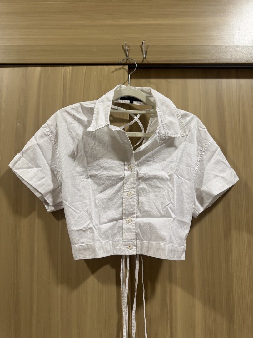 Zara Cropped Backless Polo (Category: Blouses) located in Manila. Submitted by declutterdoctor (Listing ID 1457892498, Image 1). Description: White Zara Cropped Lace Tie Polo Used once In very good condition Lace tie back detail .