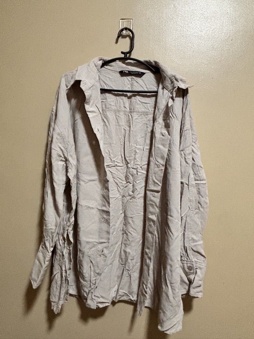 ZARA Oversized Button-Up Shirt (Category: Tshirts & Polo Shirts ) located in Leyte. Submitted by modernpersephone (Listing ID 1457867415, Image 1). Description: - ZARA Oversized Shirt - Button-up style with collar - Long sleeves with button cuffs - Color: Light beige / Off-white - Fabric: Slightly crinkled texture - Versatile: Great for layering or wearing solo Worn once only. Small-Large.