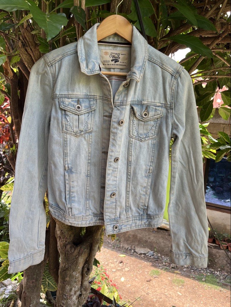 ZARA TRF Denim Jacket (Category: Coats, Jackets and Outerwear) located in Manila. Submitted by lovelynllegunas (Listing ID 1457725812, Image 1). Description: Zara TRF Denim Jacket featuring an authentic light stonewash with intentional, vintage-inspired distressing along the seams and collar. Made in 2012, this classic trucker style includes dual buttoned chest pockets and a soft, worn-in feel. Fits: Small Length: 20 Width: 15.