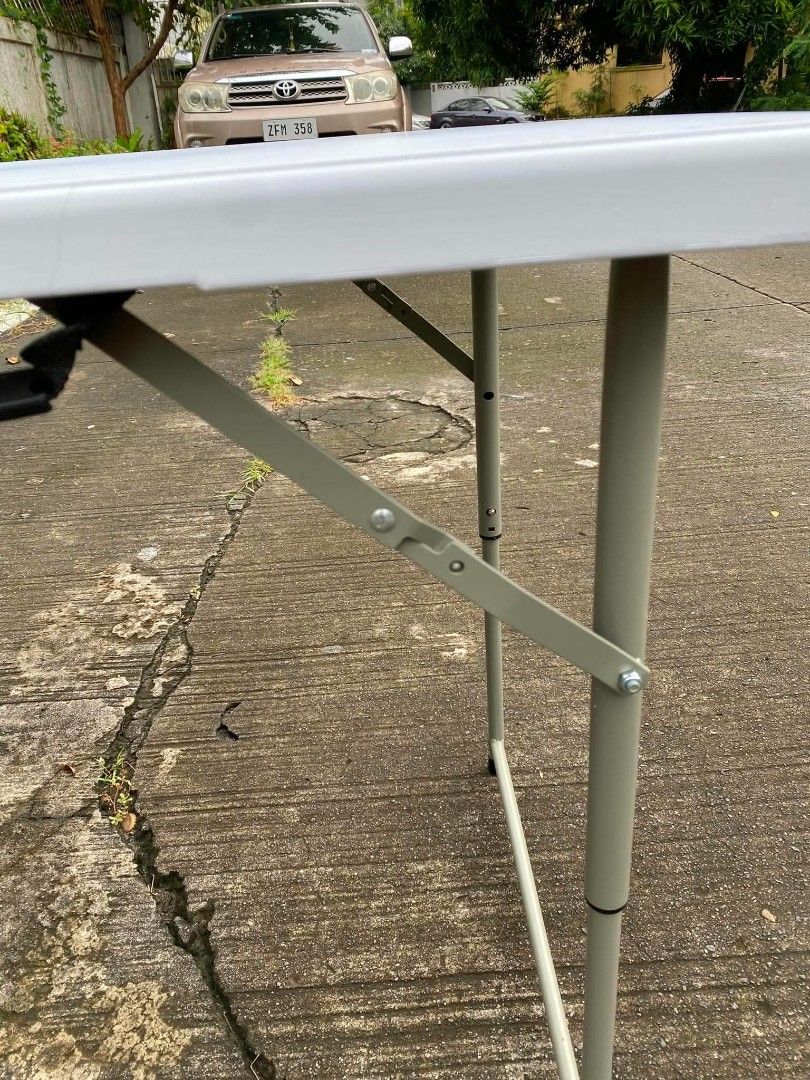 4ft adjustable White Folding Table with Metal Legs (Category: Tables & Sets) located in Manila. Submitted by shairatorres (Listing ID 1457974395, Image 3). Description: - Portable and foldable table, perfect for events or extra space. - Sturdy white tabletop with durable grey metal legs. - Folds flat for convenient storage and transport. - Features a built-in handle for easy carrying. - Versatile for both indoor and outdoor use. - Approximately 4