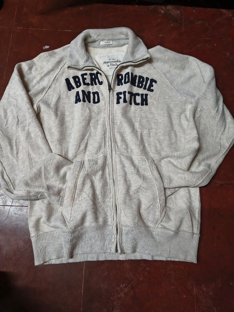 Abercrombie & Fitch Grey Zip-Up Dimes: Chest- 21 inch Length- 26 inch Sleeves- 24 inch (Category: Coats, Jackets and Outerwear) located in Aringay. Submitted by ger.0 (Listing ID 1458056351, Image 2). Description: - Grey Abercrombie & Fitch zip-up hoodie - Features brand name printed on the front - Includes pockets for convenience - Ribbed hem and cuffs for a snug fit - Ideal for casual and everyday wear -can nego.