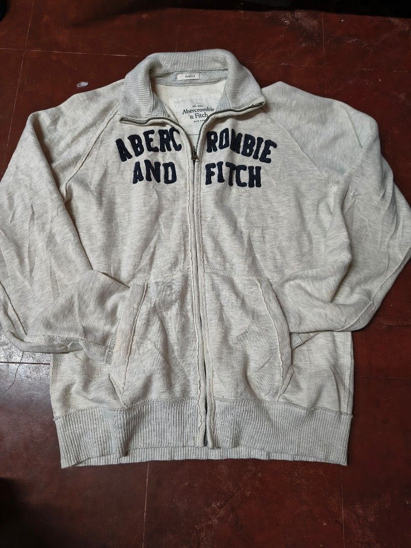 Abercrombie & Fitch Grey Zip-Up Dimes: Chest- 21 inch Length- 26 inch Sleeves- 24 inch (Category: Coats, Jackets and Outerwear) located in Aringay. Submitted by ger.0 (Listing ID 1458056351, Image 1). Description: - Grey Abercrombie & Fitch zip-up hoodie - Features brand name printed on the front - Includes pockets for convenience - Ribbed hem and cuffs for a snug fit - Ideal for casual and everyday wear -can nego.