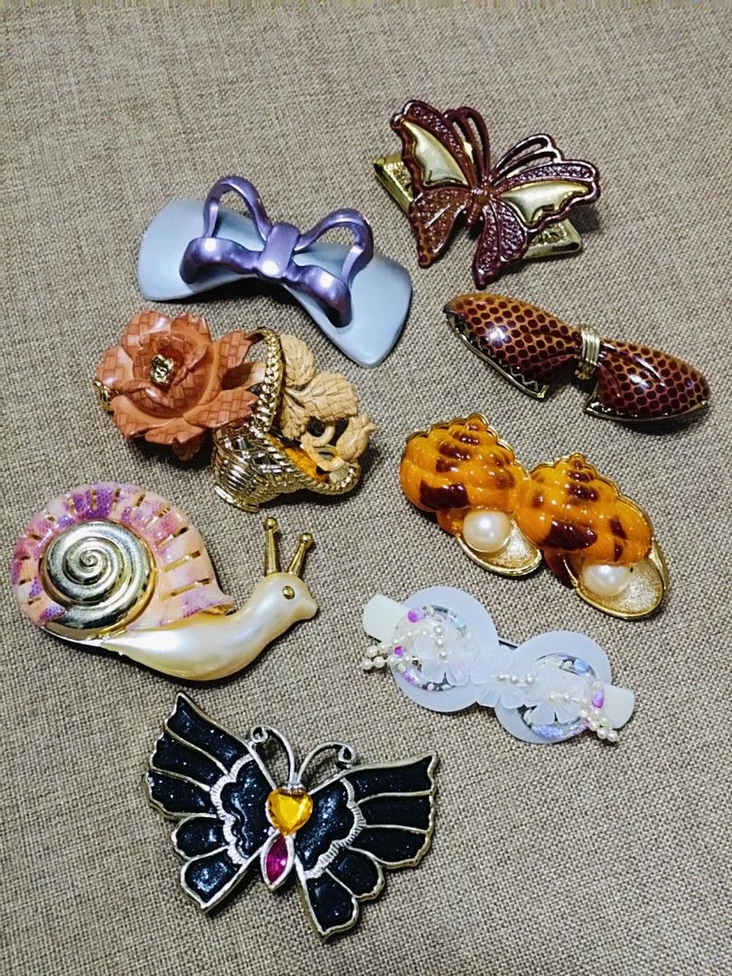 Assorted Cute Hair Clips - Butterflies, Snail, Bows, Shells (Category: Hair Accessories) located in Famy. Submitted by bujoystyle16 (Listing ID 1457911446, Image 1). Description: - Bundle of 8 unique and eye-catching hair clips. - Big Sizes - Includes: sparkly black butterfly, pearly snail with colorful shell, light blue bow, brown butterfly, 2 shell-shaped clips with pearls, brown patterned bow, and white floral clip. - Adds a fun and stylish to
