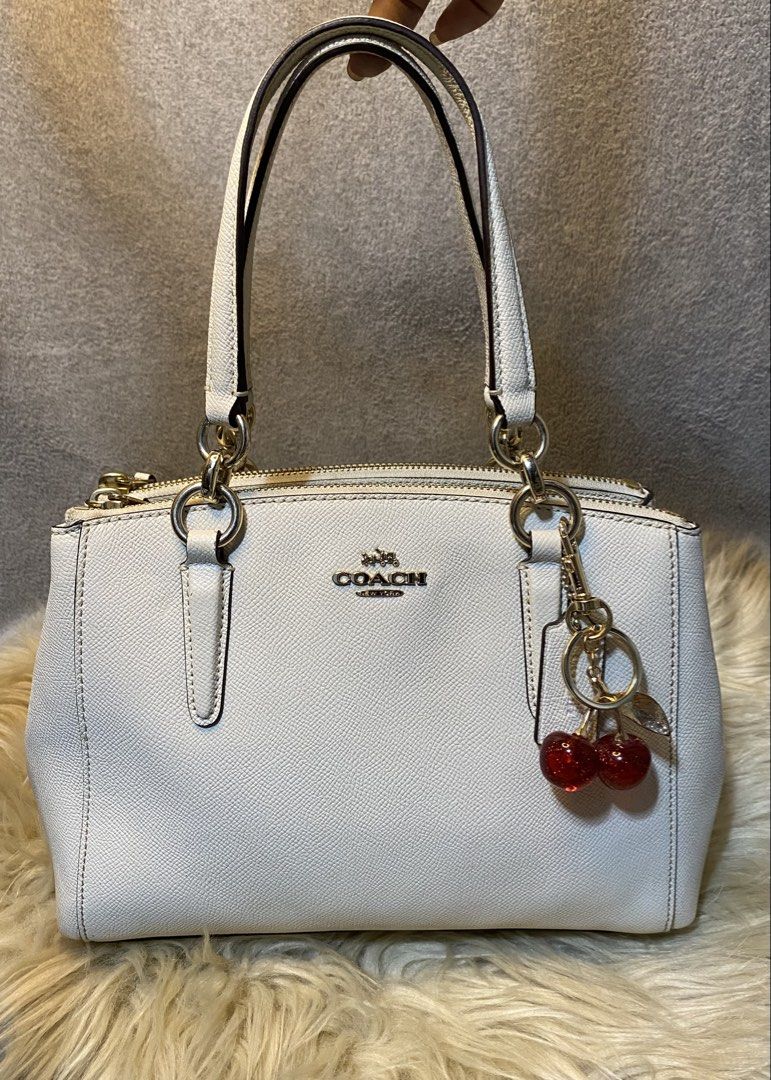 Authentic Coach Christie Carryall (Category: Luxury Bags & Wallets) located in Davao. Submitted by goldenstone_0be9b3 (Listing ID 1458066988, Image 1). Description: Authentic Coach Christie Carryall •Material: Crossgrain leather •Color: Chalk white / off-white cream •Design Features: Middle main compartment with a snap closure flanked by two zippered outer compartments. •Elegant Silver hardware details •Free keychain cherry this is so pretty! sel