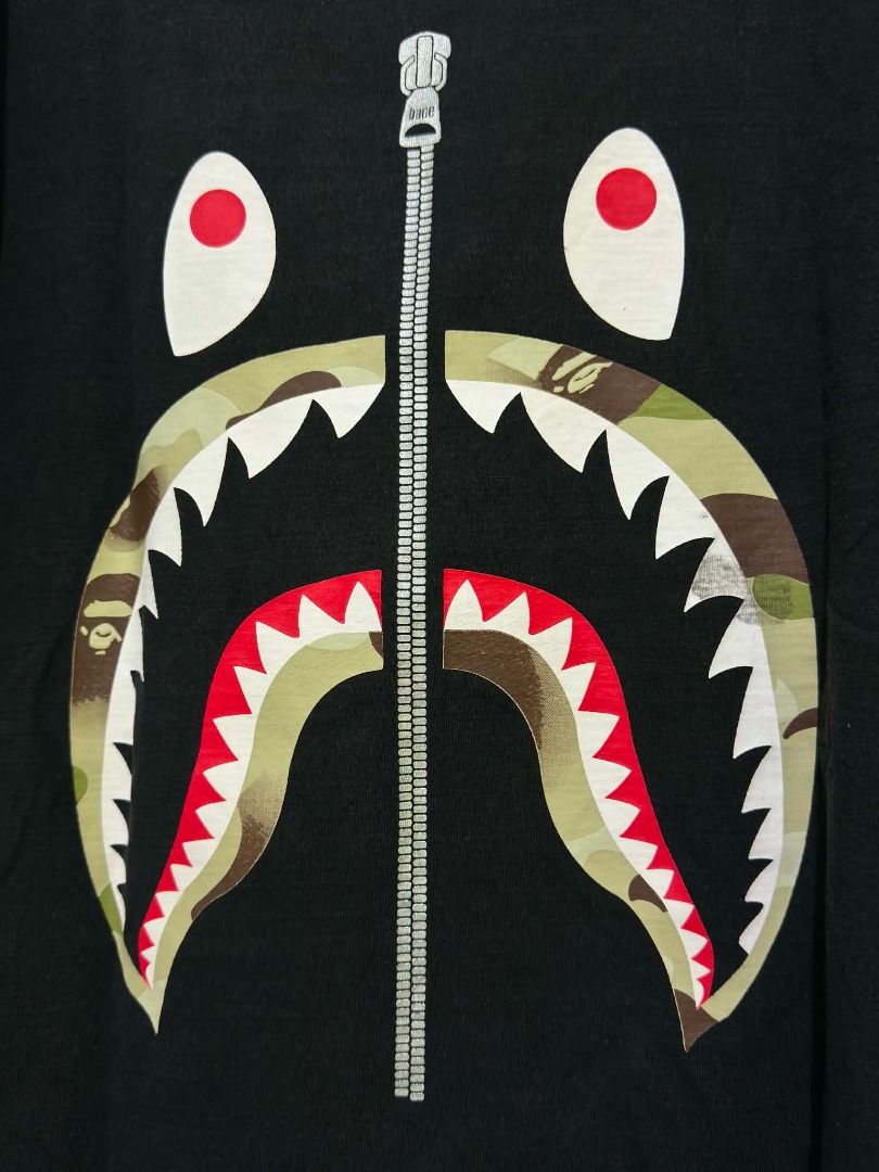 BAPE Shark Face Camo T-Shirt Black (Category: Tshirts & Polo Shirts ) located in Manila. Submitted by robin_ch23 (Listing ID 1458079018, Image 2). Description: - Classic BAPE Shark Tee - Iconic shark face graphic with camouflage print mouth - Made from 100% cotton - Tagged size L - Perfect for streetwear enthusiasts.