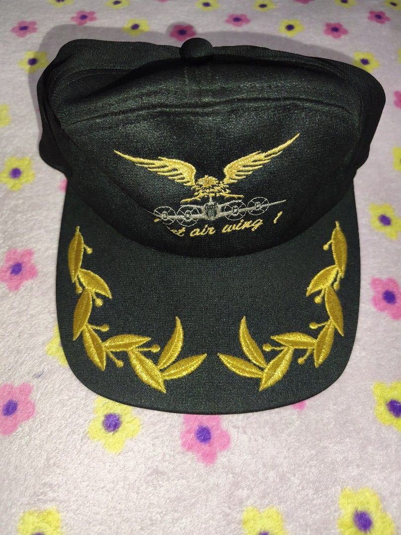 Black Air Wing Baseball Cap with Gold Embroidery (Category: Caps & Hats) located in Bulacan. Submitted by THA_D_THRIFT (Listing ID 1458077207, Image 1). Description: - Classic black baseball cap - Features intricate gold embroidery - Design includes an eagle and plane motif - 'Air Wing' text detail - Laurel leaf accents on the brim - Adjustable strap for a comfortable fit - Ideal for everyday style or as a collector's item 650 + SF.