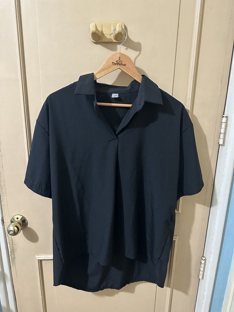 Black Short Sleeve Collared Shirt (Category: Shirts) located in Manila. Submitted by thriftchup (Listing ID 1457982974, Image 1). Description: - Black short sleeve shirt - Collared neckline with V-neck opening - Loose and comfortable fit - Ideal for casual wear or layering - Easy to style.