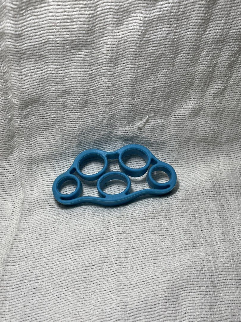 Blue Hand Grip Strengthener Finger Exerciser (Category: Hands & Nails) located in Manila. Submitted by prima_onda (Listing ID 1457964745, Image 1). Description: - Blue hand grip strengthener - Features six finger holes - Ideal for building hand and finger strength - Suitable for rehabilitation or general fitness - Easy to carry and use for workouts on the go.