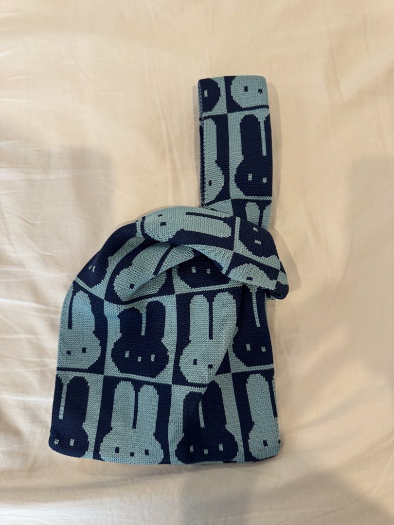 Blue Miffy Bunny Small Knit Tote Bag (Category: Tote Bags) located in Manila. Submitted by pinkyclothes1267 (Listing ID 1457967886, Image 2). Description: - Adorable blue and navy knit tote bag - Features a charming checkerboard pattern with bunny faces - Integrated handles for a seamless look and easy carrying - Lightweight and easy to carry - small but stretchy, can fit essentials (phone, wallet, etc.) .