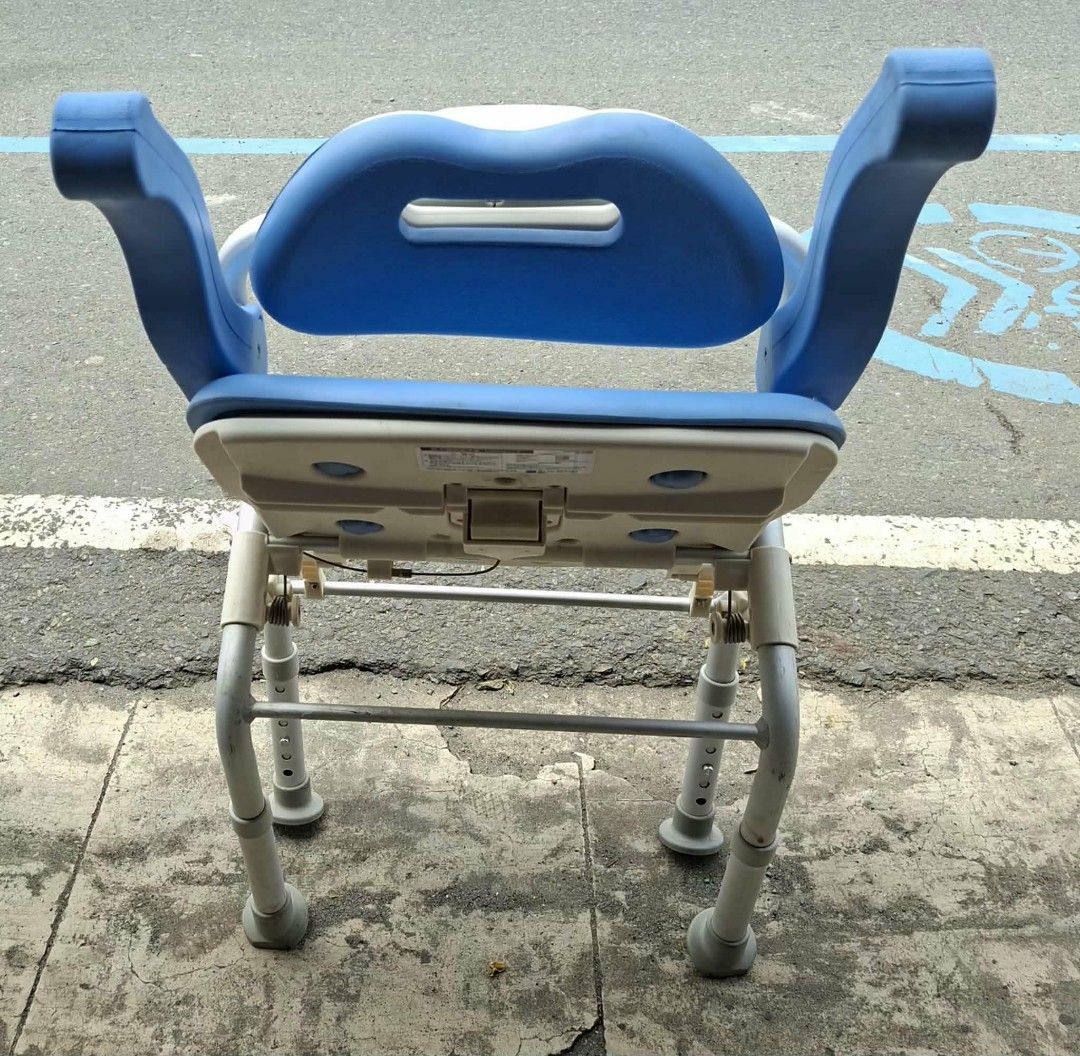 Blue Shower Chair with Backrest and Arms (Category: Chairs) located in Manila. Submitted by rocksolid227 (Listing ID 1457954185, Image 3). Description: - Blue shower chair with backrest and armrests - Features drainage holes on the seat - Sturdy metal frame for durability - Adjustable height legs for customized fit - Designed for enhanced bathroom safety - Made with easy-to-clean material.