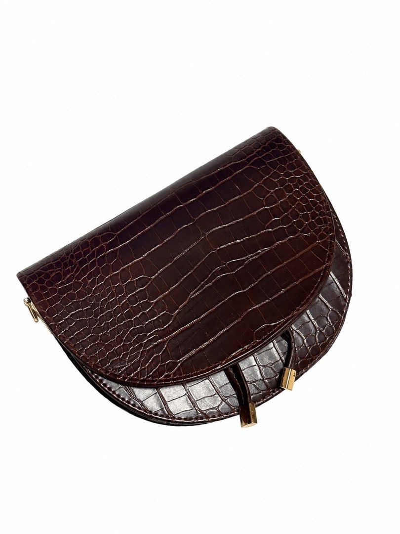 Brown Croc Embossed Saddle Bag with Adjustable Strap (Category: Luxury Bags & Wallets) located in Bacoor. Submitted by sofaritsalright (Listing ID 1457972163, Image 1). Description: - Bought from random store in Bangkok - Have to reglue the lining inside - Stylish brown saddle bag - Luxurious croc-embossed texture - Secure flap closure with elegant gold hardware - Includes a long, adjustable strap for versatile wear - Dark grey interior - Ideal f