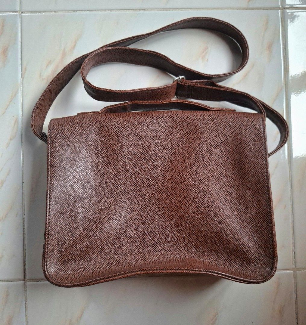 Brown Leather 2 in 1 Shoulder/Body Bag/Satchel (Category: Shoulder Bags) located in Cavite. Submitted by graciously_good (Listing ID 1437734498, Image 2). Description: - L: 8", W: 10.5", H: 3.5" - No brand - Brown leather bag satchel shoulder body bag with adjustable strap length - Some loose threads, stiff leather - Color may vary due to lighting and camera settings.