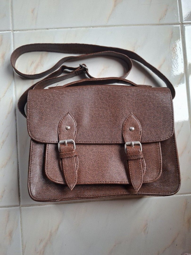 Brown Leather 2 in 1 Shoulder/Body Bag/Satchel (Category: Shoulder Bags) located in Cavite. Submitted by graciously_good (Listing ID 1437734498, Image 1). Description: - L: 8", W: 10.5", H: 3.5" - No brand - Brown leather bag satchel shoulder body bag with adjustable strap length - Some loose threads, stiff leather - Color may vary due to lighting and camera settings.