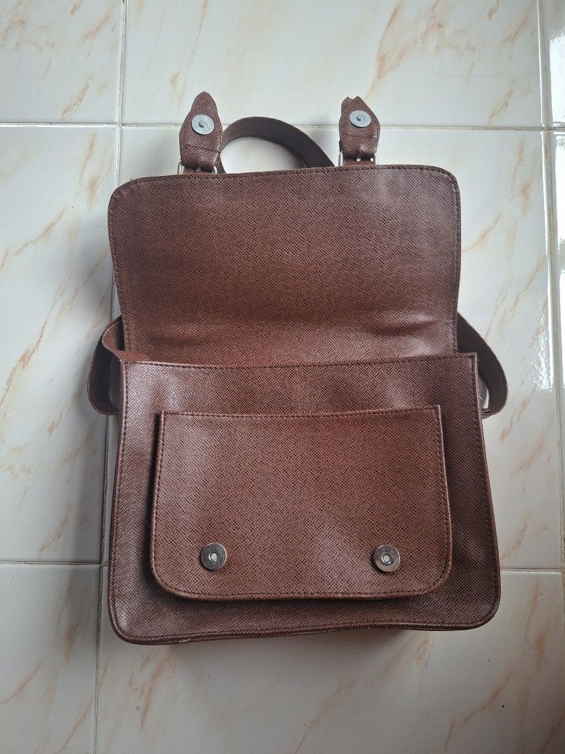 Brown Leather 2 in 1 Shoulder/Body Bag/Satchel (Category: Shoulder Bags) located in Cavite. Submitted by graciously_good (Listing ID 1437734498, Image 3). Description: - L: 8", W: 10.5", H: 3.5" - No brand - Brown leather bag satchel shoulder body bag with adjustable strap length - Some loose threads, stiff leather - Color may vary due to lighting and camera settings.