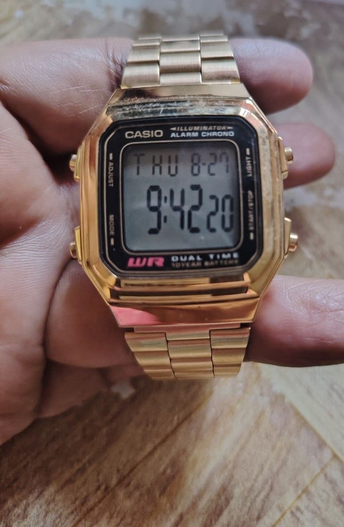 Casio Illuminator Alarm Chrono Gold Digital Watch (Category: Men's Watches) located in Manila. Submitted by lhen666 (Listing ID 1457908566, Image 1). Description: - Gold Casio digital watch - Displays day, date, and time - Features alarm and stopwatch (chrono) - Dual time capability - Water resistant - Long-lasting 10-year battery - Durable metal band - Shows some signs of wear on casing and band.